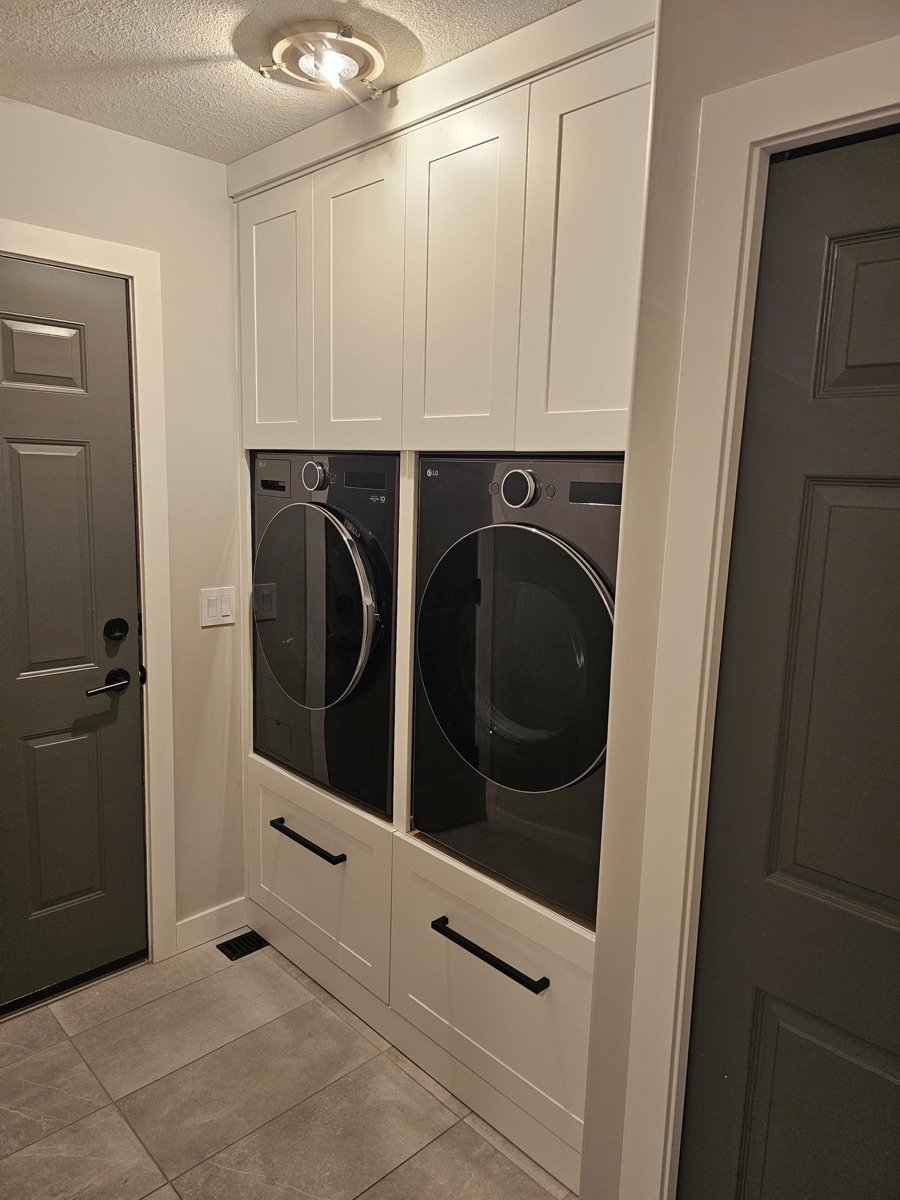 Custom white shaker laundry room cabinets Saskatoon — finished by Monarch Cabinets